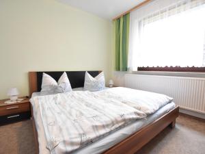 a bedroom with a large bed and a window at Beautiful Apartment in Proseken with Garden in Proseken