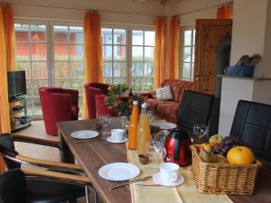 a dining room with a table with fruit on it at Allergy-friendly holiday home near the beach with lake view in Kägsdorf