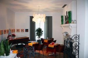comedor con piano, mesas y sillas en B11hotel, en Niza