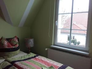 a bedroom with a bed and a window at Modern Apartment near Sea in Wismar in Wismar