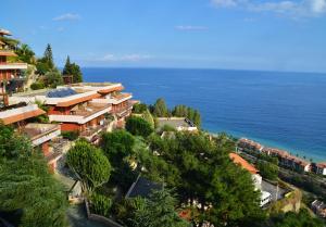 an aerial view of a resort next to the ocean at Residence Letojanni Taormina in Letojanni