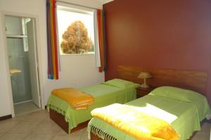 Ένα ή περισσότερα κρεβάτια σε δωμάτιο στο Pousada Águas de Caxambu