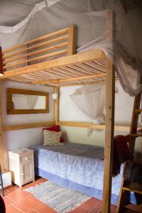 two bunk beds in a room with a bed at Guest Room B&B Agro-turismo Quinta da Fonte in Figueiró dos Vinhos
