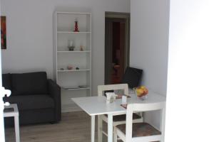 ein Wohnzimmer mit einem weißen Tisch und einer Couch in der Unterkunft "NAR" Opatija center spacious 1 bedroom apt in Opatija