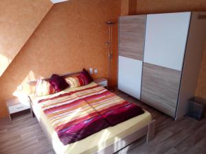 a bedroom with a bed with a large sliding door at Pension zum Ringelberg in Erfurt