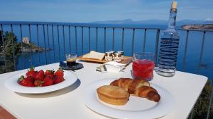 a table with two plates of food and a bottle of water at Villa Crawford in San Nicola Arcella
