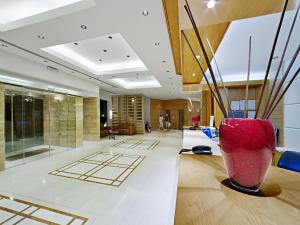 a lobby with a red vase on a table at Athineon Hotel in Rhodes Town
