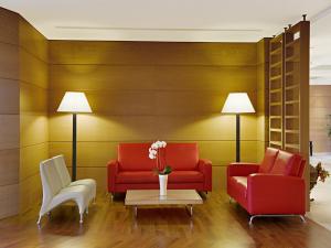 a living room with two red chairs and a table at Athineon Hotel in Rhodes Town