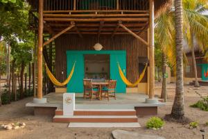 a patio area with a table, chairs, and tables at Aite Eco Resort in Palomino