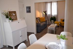 a living room with a table and a white cabinet at The blue house las Canteras in Las Palmas de Gran Canaria