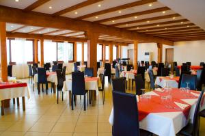 a restaurant with tables and chairs in a room at Residence Letojanni Taormina in Letojanni