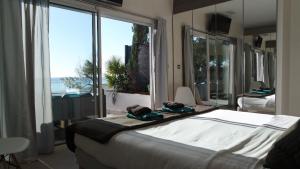 a bedroom with a bed and a large window at Villa Perle De La Mer in Saint-Aygulf +123 photos