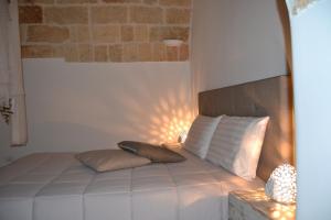 a bed with two pillows on it in a room at Mare Nostrum Locazione Turistica in Polignano a Mare