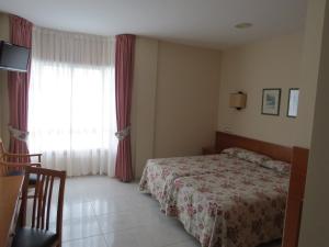 Cama o camas de una habitación en Hotel Nuevo Lanzada