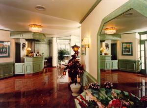 a lobby with a large mirror and flowers in it at Hotel Heuberg in Norderstedt