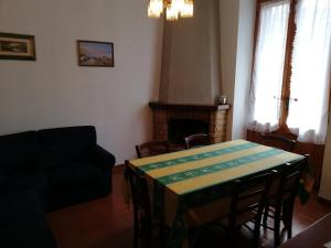 a living room with a table and a fireplace at Appartamento Il Pianetto in Celle sul Rigo