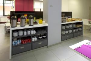 a kitchen with a counter with cups and dishes at Hotel Vila da Guarda in A Guarda