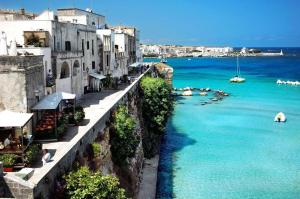 a view of a body of water with buildings at HYPOGEUM -Le Torri Apartments- in Otranto