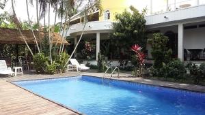 a swimming pool in front of a house at Ga&iuml;a's Garden B&B Abidjan in Abidjan