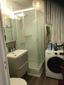 a bathroom with a shower and a washing machine at Pilatre de Rosier proximité plage in Wimereux