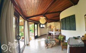 a living room with a room with a bed and a table at Paua Hotel Boutique in Pipa