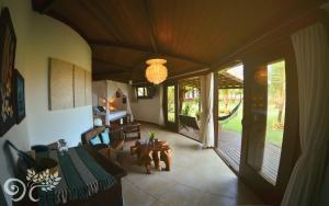 a living room with a couch and a table and chairs at Paua Hotel Boutique in Pipa