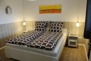 a bed in a room with two pillows on it at Haus Kornfeld in Oberlangen