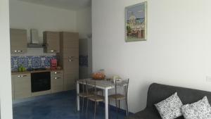 a small kitchen with a table and a couch at Citara mare in Forio d'Ischia
