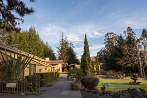 a house with a garden and a lawn with trees at Sonoma Coast Villa in Bodega