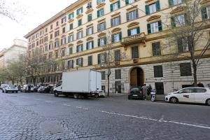 a white truck parked in front of a large building at romantica guest house in Rome
