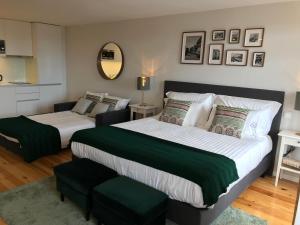 Uma cama ou camas num quarto em Virtudes City Lofts