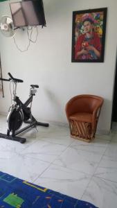 a room with a television and a bike and a picture at Casa Santuario Hotel Boutique in Guadalajara