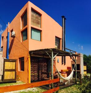 una casa con una hamaca delante en Nao Tem Fim, en Punta del Diablo