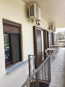 a balcony with chairs and a heater on a building at Platanos Rooms in Anopoli Sfakion