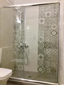 a shower with a glass door in a bathroom at Platanos Rooms in Anopoli Sfakion