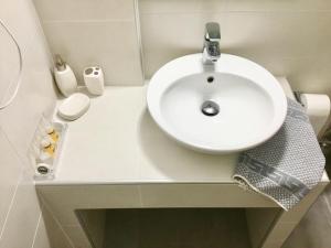 a bathroom with a sink and a white sink at Platanos Rooms in Anopoli Sfakion