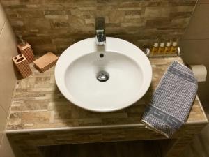 a white sink in a bathroom with at Platanos Rooms in Anopoli Sfakion