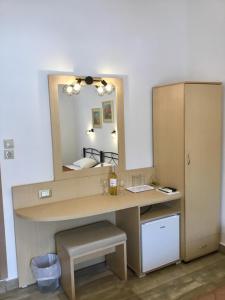a dressing room with a desk and a mirror at Platanos Rooms in Anopoli Sfakion