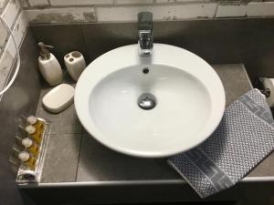 a white sink in a bathroom with at Platanos Rooms in Anopoli Sfakion
