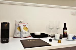 a table with a bottle of wine and wine glasses at romantica guest house in Rome