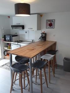 a kitchen with a wooden table and some stools at Duc's House in Frozes