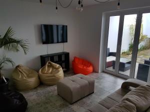 a living room with a couch and a flat screen tv at City's Hostel Ponta Delgada in Ponta Delgada