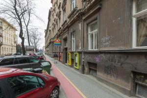 a red car parked on a street next to a building at Montevideo Deluxe Apartments in Zagreb