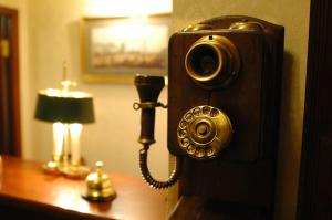 a telephone on a wall next to a desk with a lamp at Silver Age in Saint Petersburg