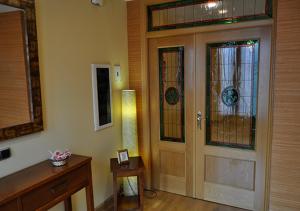 a room with a door with stained glass windows at Hostal Puerta del Valle in Valladolid