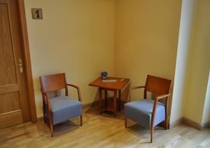 a room with two chairs and a table and a table at Hostal Puerta del Valle in Valladolid