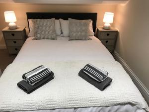 two black and white towels on a white bed at Parliament in Gloucester