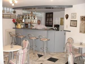 a man standing behind a bar in a restaurant at Elena Studios in Chania