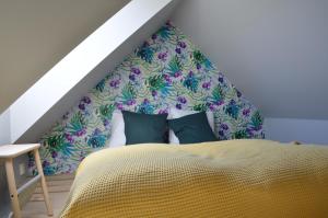a bedroom with a bed with a flowery headboard at MB Apartments in Bergen