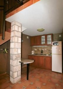 a kitchen with a table in the middle of it at House on the beach in Kotor +9 photos